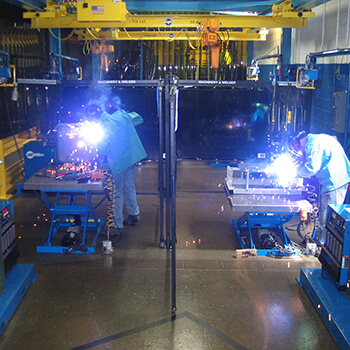 two welders manually welding parts and assemblies in Wisconsin